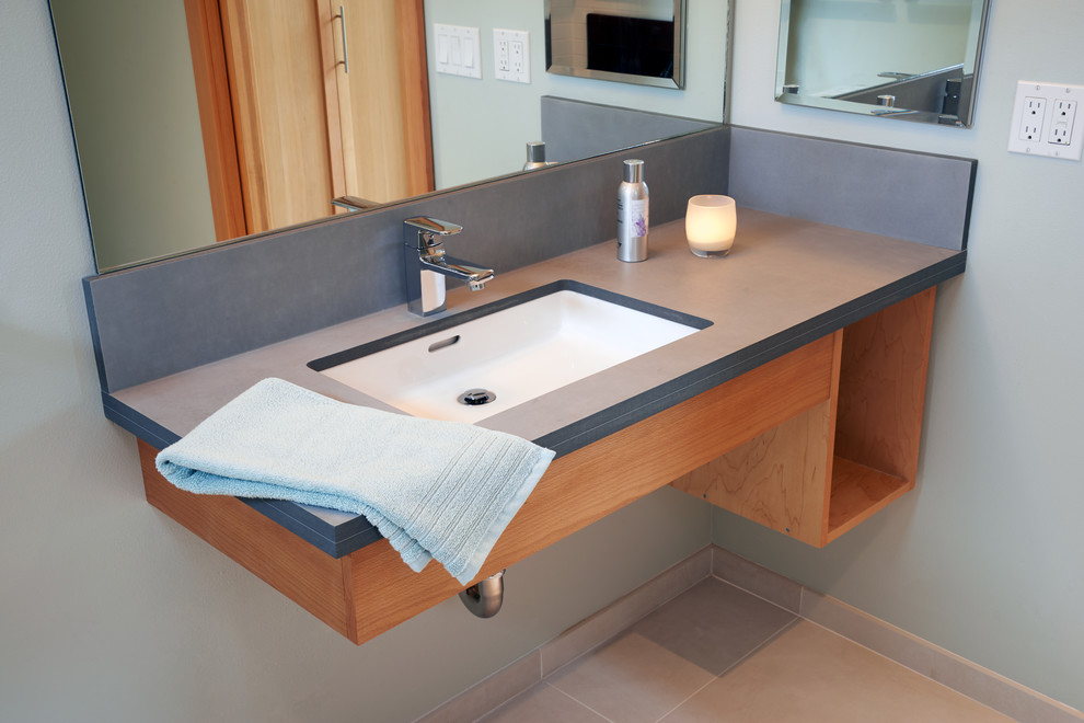 Medium sized contemporary ensuite bathroom in Seattle with flat-panel cabinets, medium wood cabinets, a built-in shower, a two-piece toilet, white tiles, metro tiles, white walls, ceramic flooring, a submerged sink and soapstone worktops.