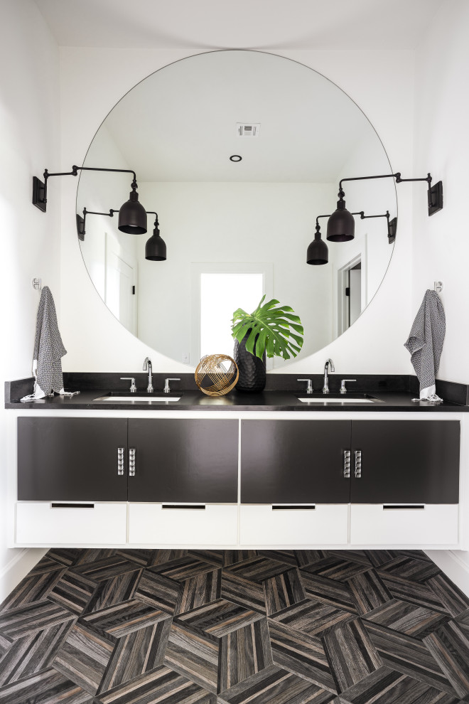 Rural bathroom in Oklahoma City with flat-panel cabinets, black cabinets, white walls, a submerged sink, grey floors, black worktops, double sinks and a floating vanity unit.