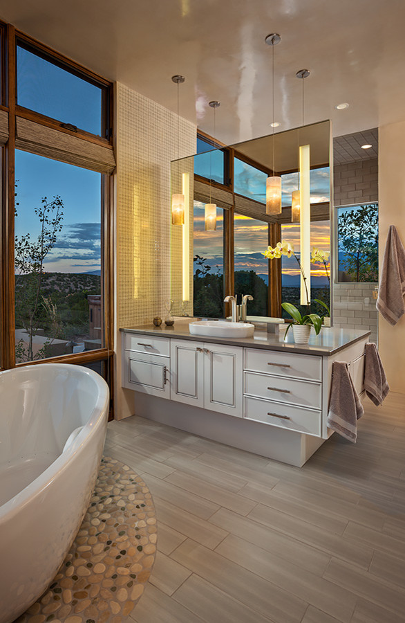 Inspiration for a large southwestern master ceramic tile bathroom remodel in Albuquerque with raised-panel cabinets, white cabinets, white walls, a vessel sink and solid surface countertops