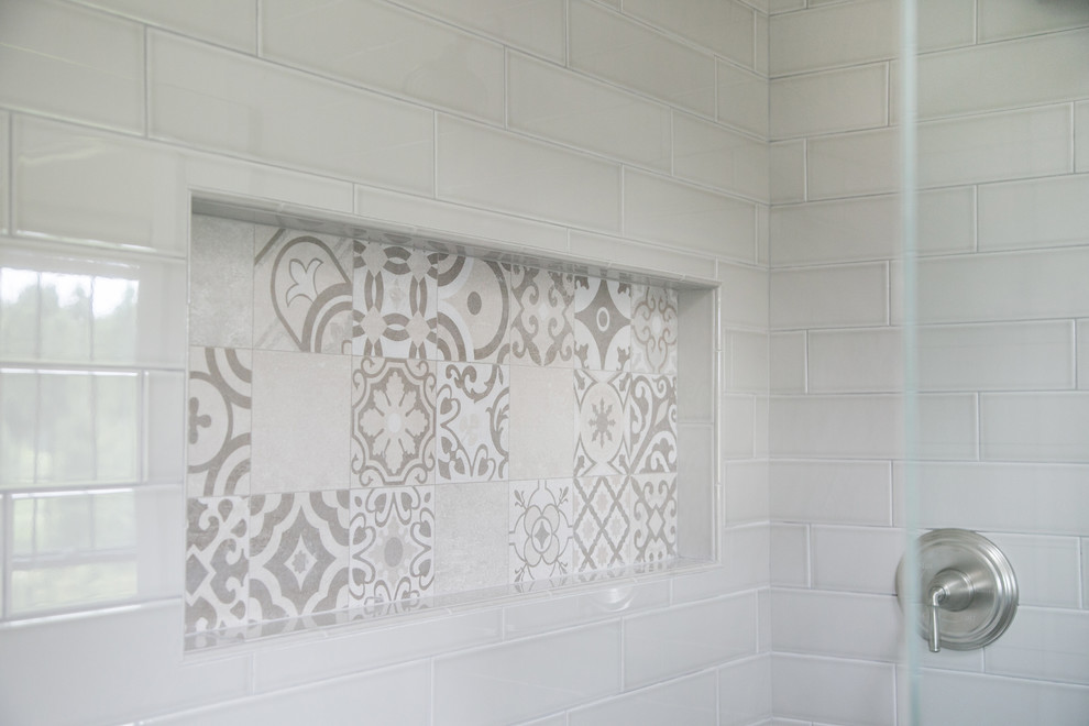 На фото: главная ванная комната в стиле кантри с угловым душем, белой плиткой, керамогранитной плиткой, белыми стенами, белым полом, душем с распашными дверями и серой столешницей с