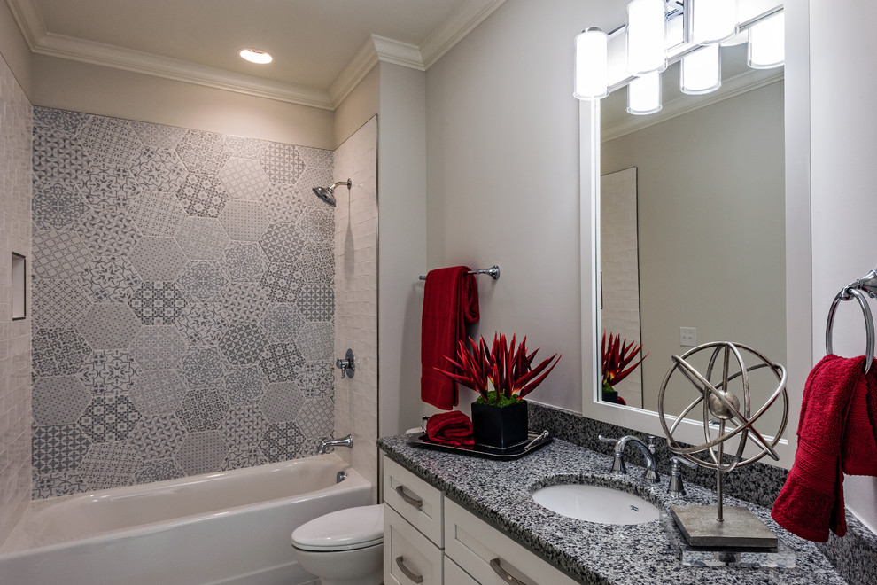Bathroom - mid-sized transitional 3/4 gray tile, white tile and ceramic tile bathroom idea in Charlotte with shaker cabinets, white cabinets, a two-piece toilet, white walls, an undermount sink and granite countertops