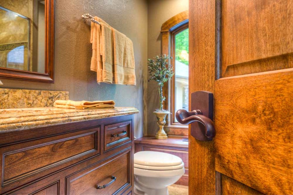 This is an example of a large traditional ensuite bathroom in Other with medium wood cabinets and brown walls.