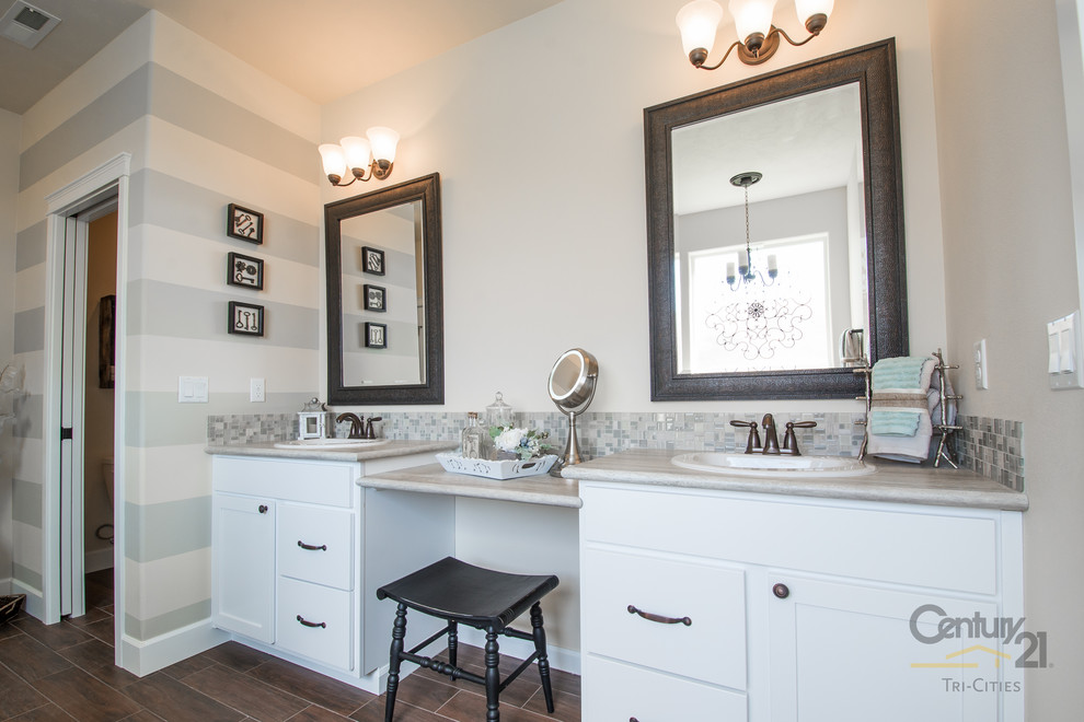 Large mountain style master gray tile and glass tile linoleum floor bathroom photo in Seattle with a drop-in sink, shaker cabinets, white cabinets, granite countertops, a two-piece toilet and beige walls