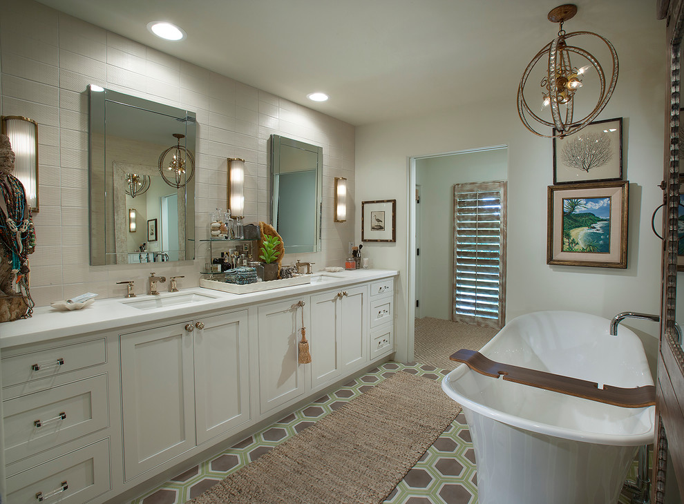 Example of a mid-sized eclectic master white tile and stone tile ceramic tile bathroom design in Phoenix with an undermount sink, recessed-panel cabinets, white cabinets, a two-piece toilet and white walls