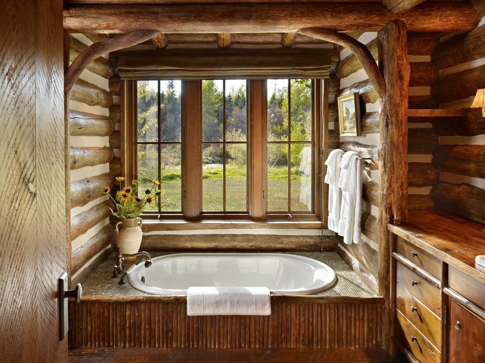 Drop-in bathtub - large rustic master drop-in bathtub idea in Other with dark wood cabinets, brown walls, wood countertops, furniture-like cabinets and brown countertops