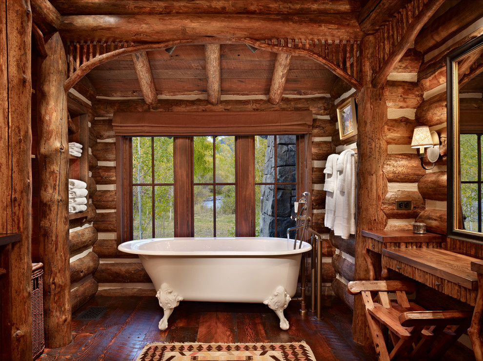 This is an example of a rustic bathroom in Other with a claw-foot bath.