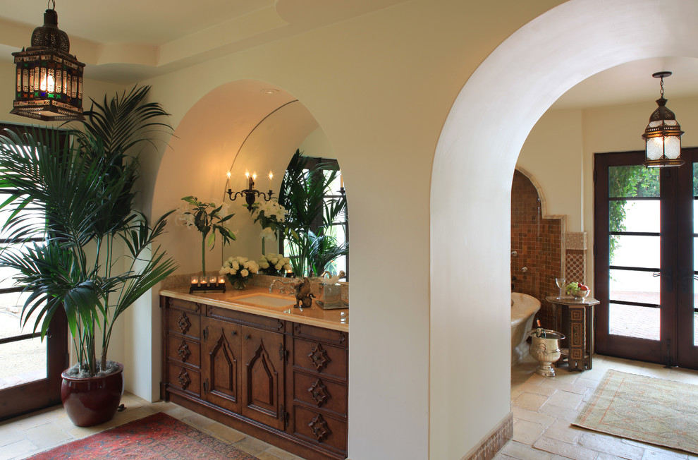 This is an example of a mediterranean bathroom in Phoenix with recessed-panel cabinets.