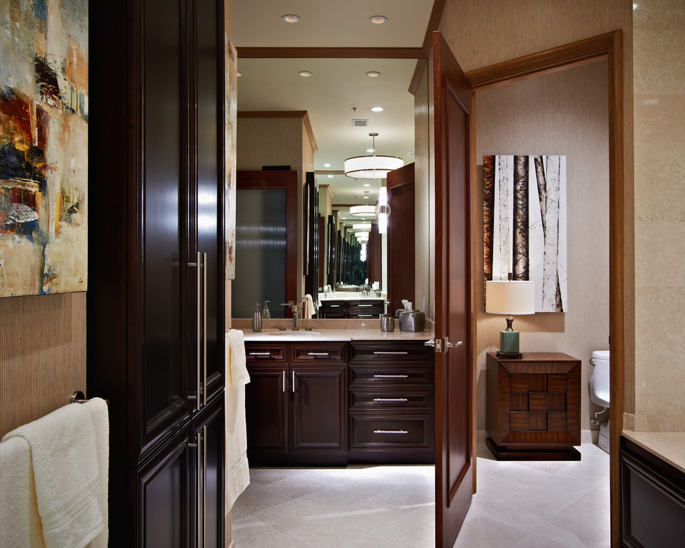 Design ideas for a contemporary bathroom in Raleigh with dark wood cabinets and an enclosed toilet.