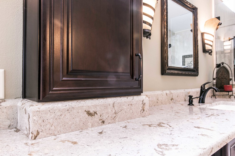 Bild på ett stort vintage en-suite badrum, med luckor med upphöjd panel, bruna skåp, en hörndusch, flerfärgad kakel, porslinskakel, travertin golv, ett undermonterad handfat, bänkskiva i kvarts och flerfärgat golv