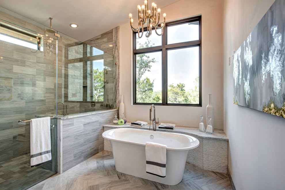 Inspiration for an expansive contemporary ensuite bathroom in Austin with a submerged sink, shaker cabinets, grey cabinets, marble worktops, a freestanding bath, a double shower, a two-piece toilet, grey tiles, stone tiles, white walls and marble flooring.