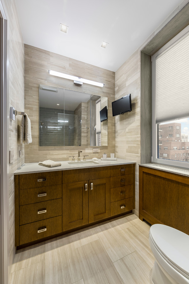 Inspiration for a mid-sized contemporary master brown tile and stone tile porcelain tile alcove shower remodel in New York with an undermount sink, flat-panel cabinets, medium tone wood cabinets, marble countertops, a one-piece toilet and brown walls
