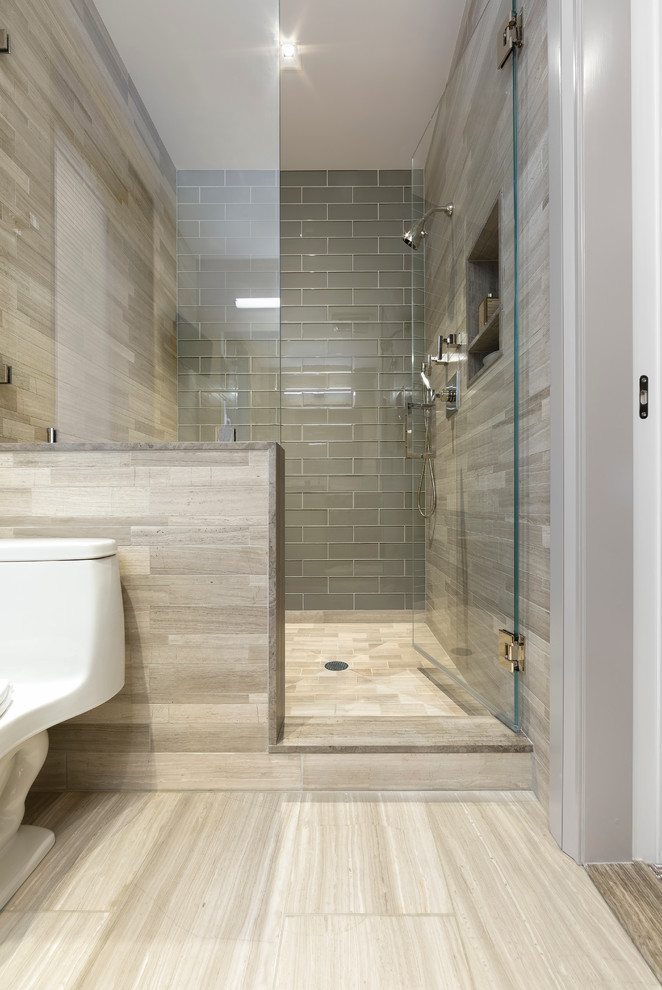 Inspiration for a medium sized contemporary ensuite bathroom in New York with a submerged sink, flat-panel cabinets, medium wood cabinets, marble worktops, an alcove shower, a one-piece toilet, brown tiles, stone tiles, brown walls and porcelain flooring.