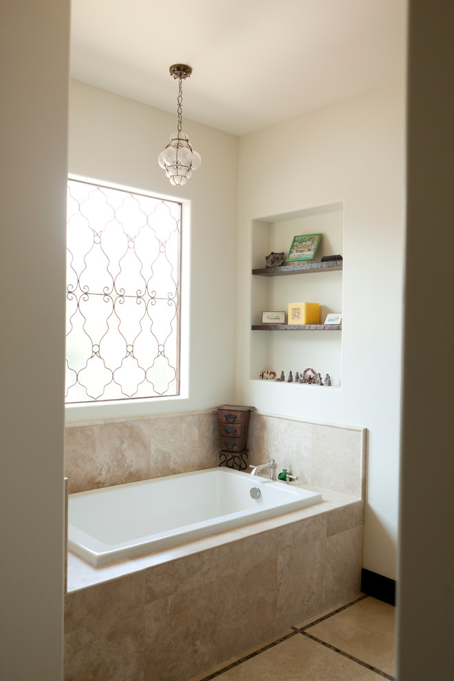 Elegant beige tile drop-in bathtub photo in Dallas