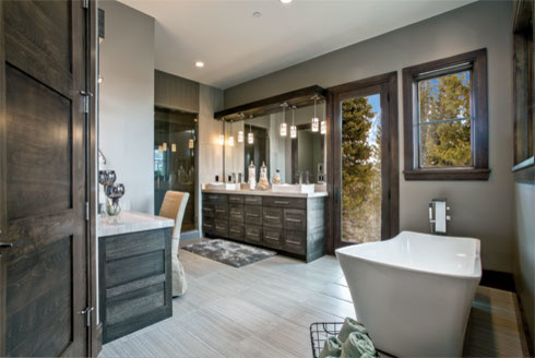 Example of a trendy dark wood floor freestanding bathtub design in Salt Lake City with dark wood cabinets, gray walls and a vessel sink