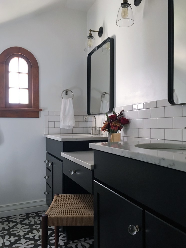 Photo of a medium sized traditional ensuite bathroom in Phoenix with shaker cabinets, black cabinets, white tiles, white walls, a submerged sink, engineered stone worktops, a corner shower and cement flooring.