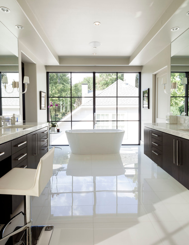 Photo of a large traditional ensuite bathroom in Dallas with flat-panel cabinets, dark wood cabinets, a freestanding bath, white walls and marble worktops.
