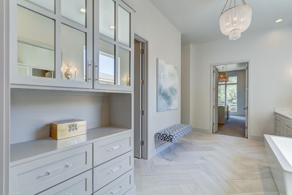 Large transitional master gray tile and stone tile limestone floor bathroom photo in Oklahoma City with recessed-panel cabinets, white cabinets, a two-piece toilet, gray walls, an undermount sink and quartzite countertops
