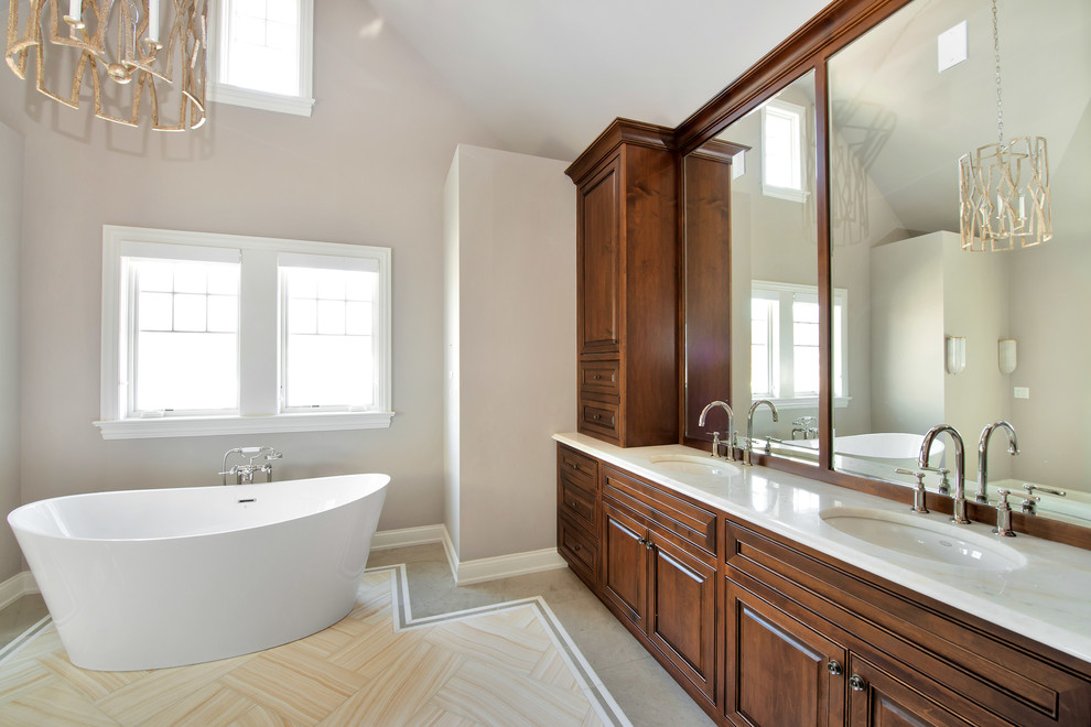Klassisk inredning av ett mellanstort en-suite badrum, med möbel-liknande, skåp i mörkt trä, ett fristående badkar, en dusch i en alkov, vit kakel, grå väggar, ett integrerad handfat, klinkergolv i terrakotta, marmorbänkskiva och beiget golv