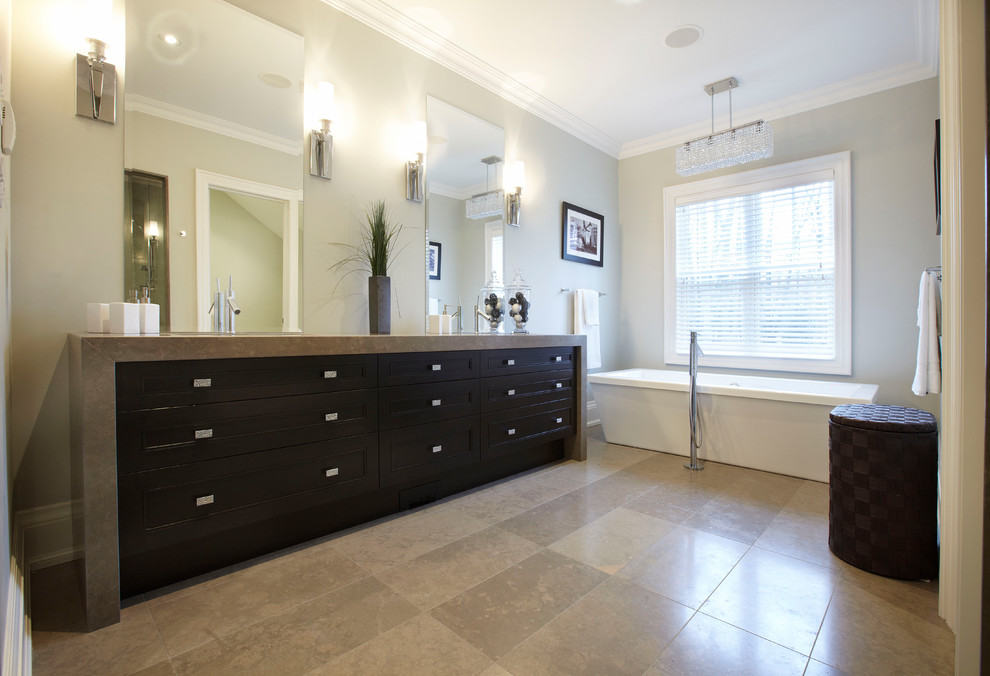Example of a large transitional master brown tile freestanding bathtub design in Toronto with recessed-panel cabinets, dark wood cabinets, gray walls and an undermount sink