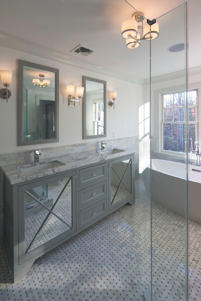 Inspiration for a large traditional ensuite bathroom in New York with beaded cabinets, grey cabinets, a freestanding bath, grey tiles, stone tiles, white walls, marble flooring and marble worktops.