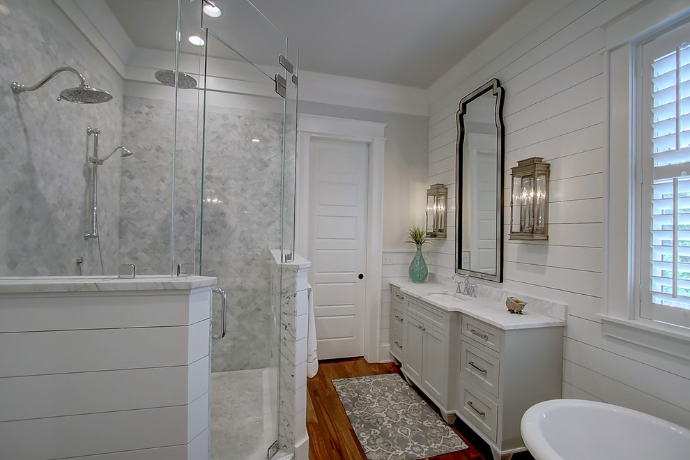 Large elegant master white tile medium tone wood floor bathroom photo in Charleston with shaker cabinets, white cabinets, white walls, an undermount sink and marble countertops