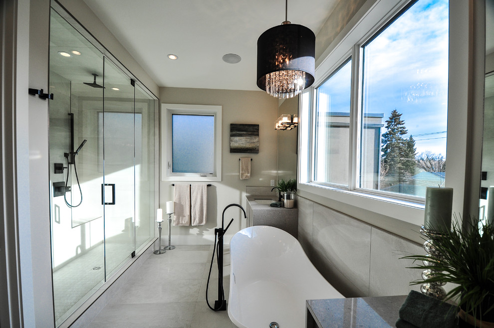 Design ideas for a contemporary ensuite bathroom in Calgary with a freestanding bath and a double shower.