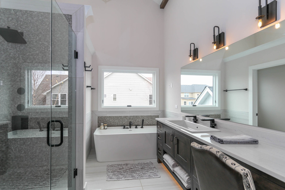Medium sized farmhouse family bathroom in Chicago with shaker cabinets, black cabinets, a walk-in shower, a one-piece toilet, beige tiles, ceramic tiles, beige walls, ceramic flooring, a pedestal sink, engineered stone worktops, grey floors, a sliding door and white worktops.