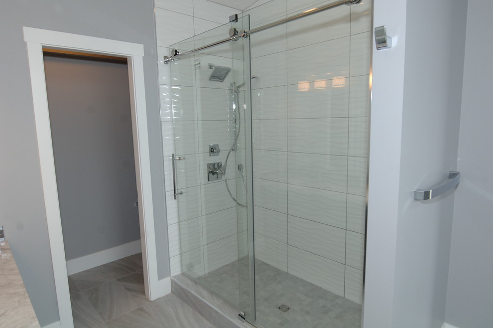 Photo of a medium sized contemporary ensuite bathroom in Edmonton with flat-panel cabinets, grey cabinets, a corner shower, grey walls, ceramic flooring and a submerged sink.