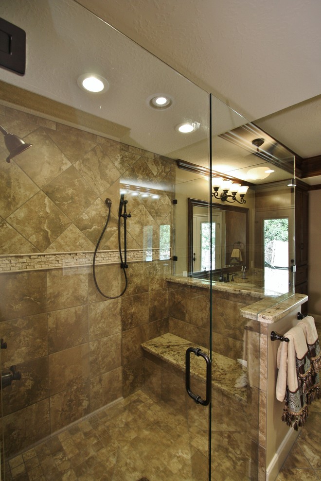 Inspiration for a large traditional ensuite bathroom in Houston with a submerged sink, recessed-panel cabinets, dark wood cabinets, granite worktops, a double shower, a two-piece toilet, beige tiles, porcelain tiles, beige walls and porcelain flooring.