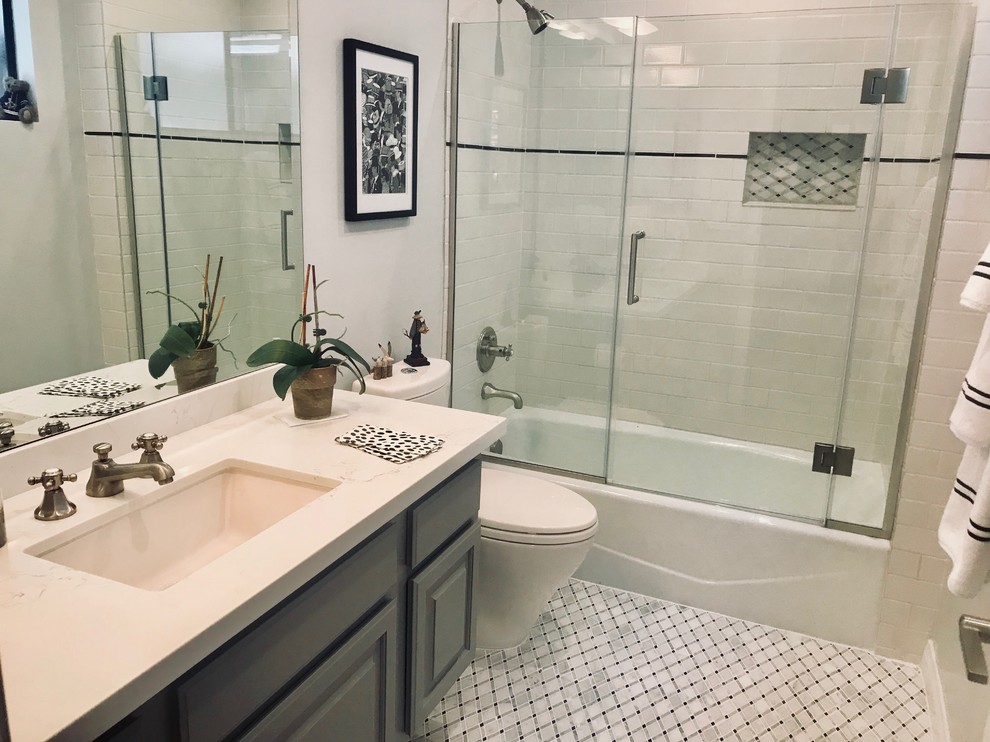 Example of a small trendy 3/4 white tile and subway tile marble floor and white floor bathroom design in Los Angeles with raised-panel cabinets, gray cabinets, a two-piece toilet, white walls, an undermount sink, quartz countertops, a hinged shower door and white countertops