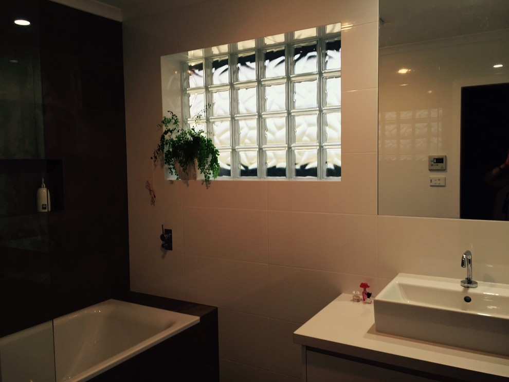 Bild på ett funkis badrum för barn, med släta luckor, vita skåp och bänkskiva i kvarts