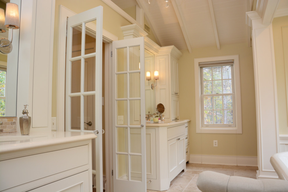 Inspiration for a mid-sized mediterranean master beige tile beige floor, double-sink and shiplap ceiling bathroom remodel in Baltimore with recessed-panel cabinets, beige cabinets, yellow walls, an undermount sink, quartz countertops, a hinged shower door, beige countertops and a freestanding vanity
