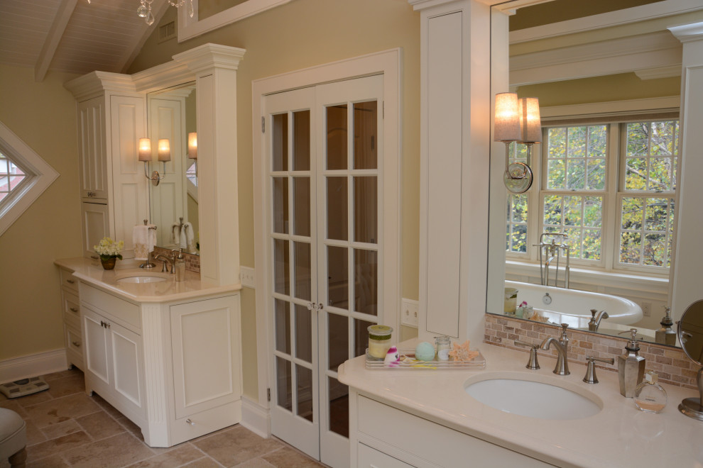 Medium sized mediterranean ensuite bathroom in Baltimore with recessed-panel cabinets, beige cabinets, a freestanding bath, an alcove shower, beige tiles, yellow walls, a submerged sink, engineered stone worktops, beige floors, a hinged door, beige worktops, double sinks, a freestanding vanity unit and a timber clad ceiling.