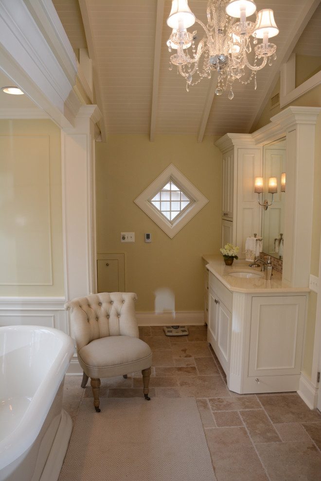 Inspiration for a medium sized mediterranean ensuite bathroom in Baltimore with recessed-panel cabinets, beige cabinets, a freestanding bath, an alcove shower, beige tiles, yellow walls, a submerged sink, engineered stone worktops, beige floors, a hinged door, beige worktops, double sinks, a freestanding vanity unit and a timber clad ceiling.