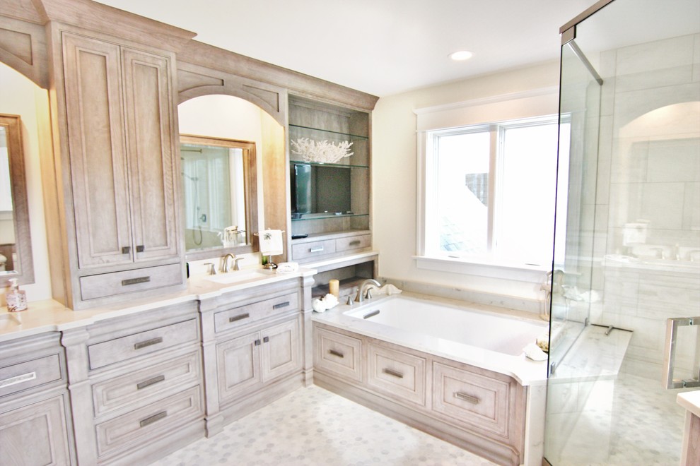 Corner shower - mid-sized transitional master white tile and ceramic tile marble floor and multicolored floor corner shower idea in Baltimore with recessed-panel cabinets, gray cabinets, an undermount tub, an undermount sink, quartz countertops and a hinged shower door