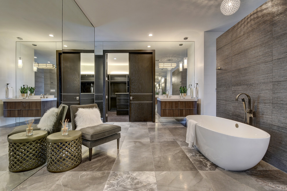 This is an example of a contemporary ensuite bathroom in Austin with flat-panel cabinets, medium wood cabinets, a freestanding bath, brown tiles, a console sink and white walls.