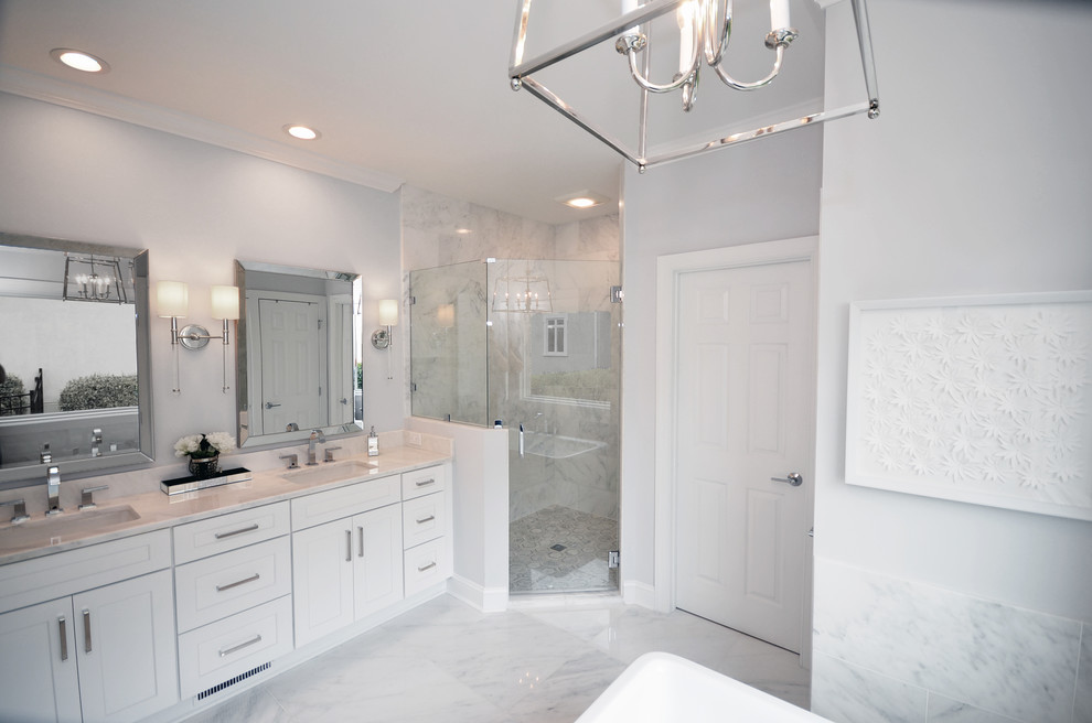 Design ideas for a medium sized nautical bathroom in Charlotte with shaker cabinets, white cabinets, a freestanding bath, a corner shower, white tiles, marble tiles, grey walls, marble flooring, a submerged sink, marble worktops, white floors, a hinged door and white worktops.
