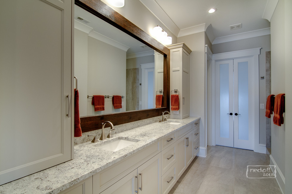 Inspiration for a traditional ensuite bathroom in Charlotte with shaker cabinets, white cabinets, an alcove shower, a two-piece toilet, beige tiles, porcelain tiles, beige walls, porcelain flooring, a built-in sink and granite worktops.