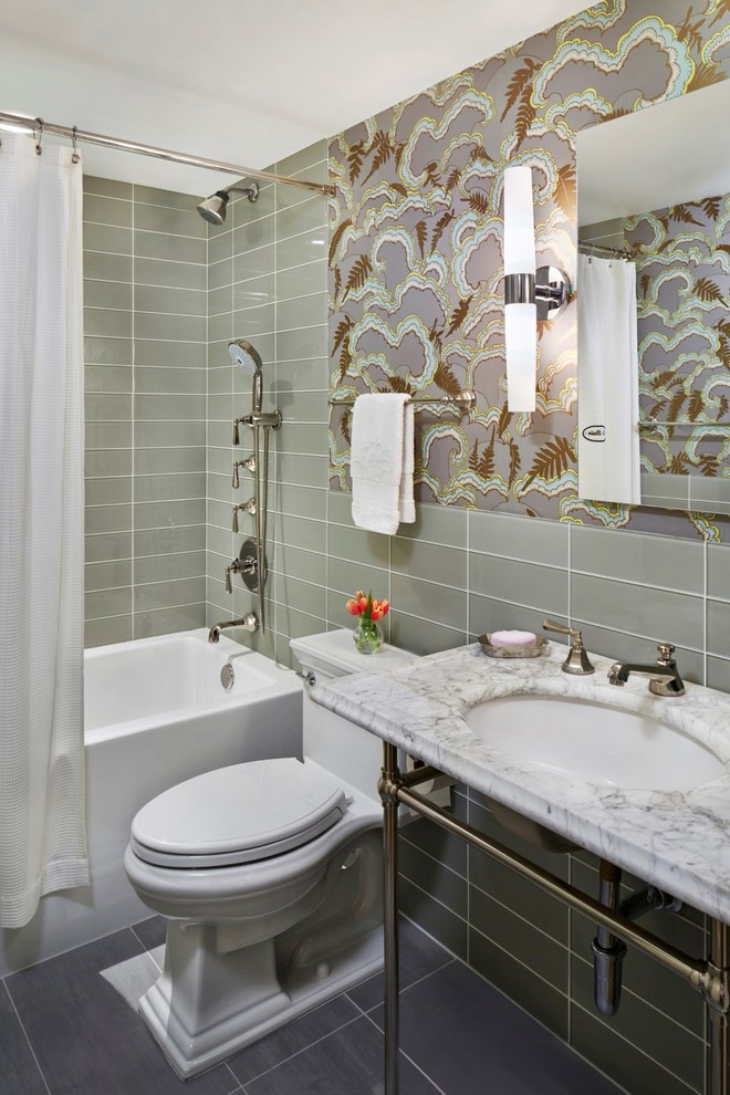 Mid-sized transitional 3/4 gray tile and glass tile porcelain tile bathroom photo in New York with a one-piece toilet, multicolored walls, a console sink and marble countertops