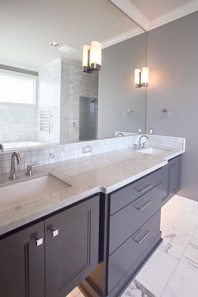 Inspiration for a medium sized classic ensuite bathroom in Portland with freestanding cabinets, medium wood cabinets, a freestanding bath, beige tiles, stone tiles, grey walls, marble flooring, a submerged sink, tiled worktops and white floors.