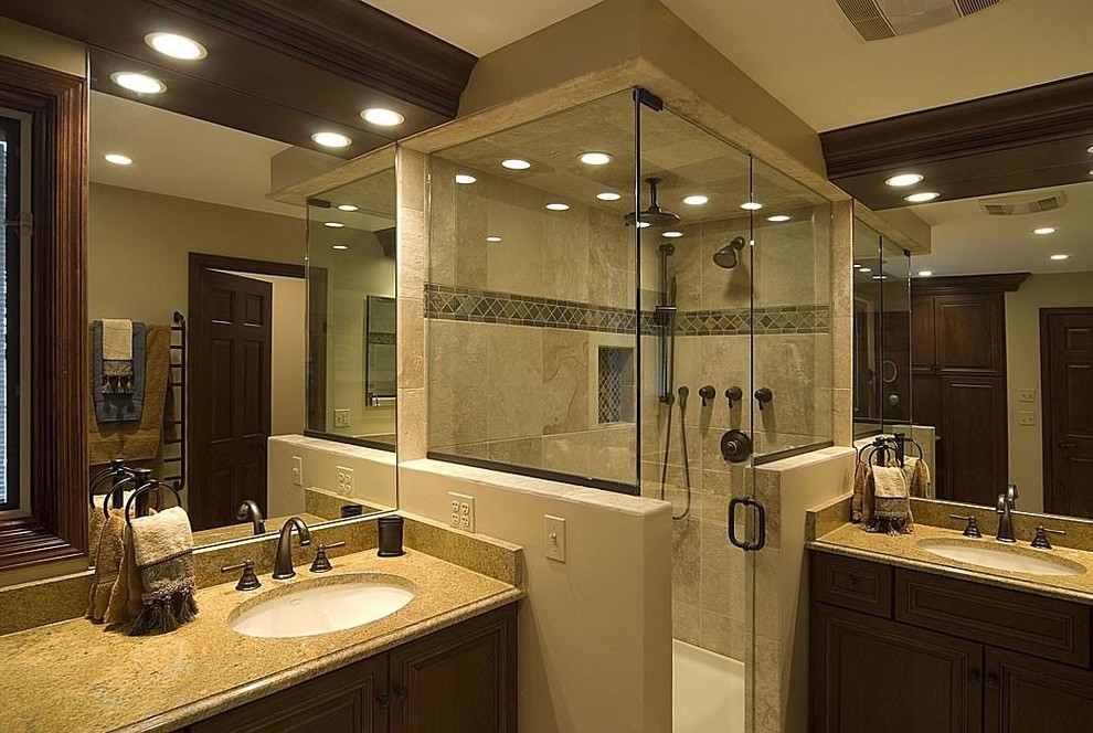 This is an example of a large traditional ensuite bathroom in Atlanta with dark wood cabinets, a corner shower, a one-piece toilet, beige tiles, ceramic tiles, a submerged sink, granite worktops and a hinged door.
