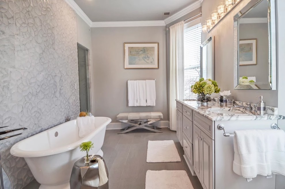 Inspiration for a mid-sized transitional master gray tile and cement tile porcelain tile and gray floor bathroom remodel in Chicago with raised-panel cabinets, gray walls, an undermount sink, marble countertops, a hinged shower door and gray cabinets
