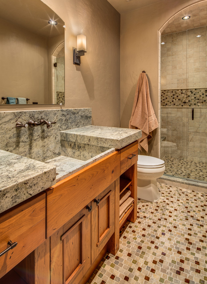 Inspiration for a mid-sized rustic master mosaic tile floor alcove shower remodel in Denver with recessed-panel cabinets, medium tone wood cabinets, beige walls and an integrated sink