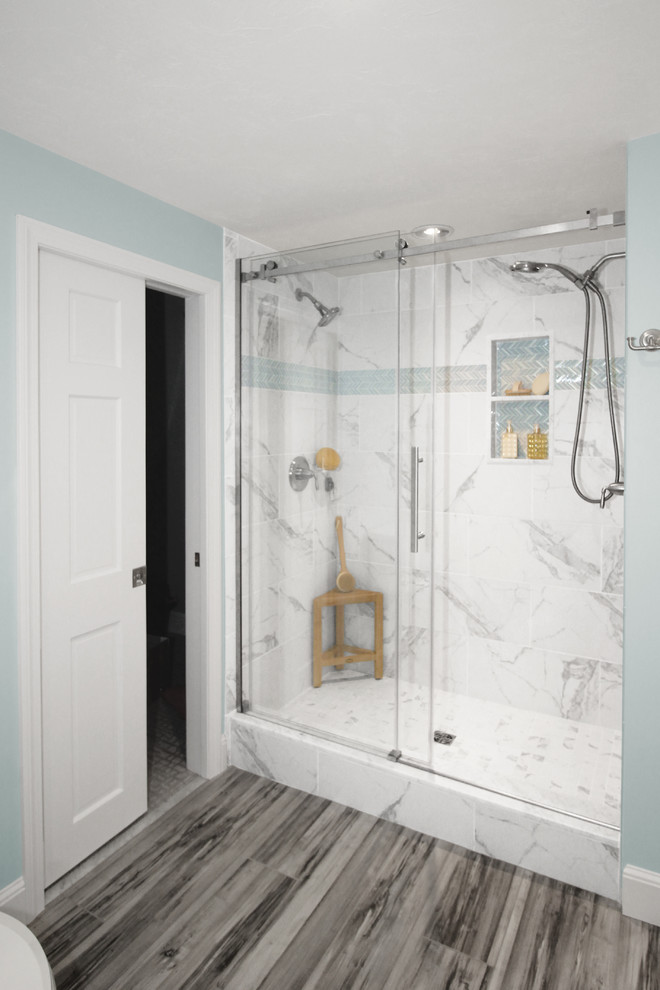 Inspiration for a medium sized traditional ensuite bathroom in Boston with shaker cabinets, distressed cabinets, an alcove shower, a two-piece toilet, white tiles, ceramic tiles, blue walls, ceramic flooring, a submerged sink, engineered stone worktops, grey floors, a sliding door and white worktops.