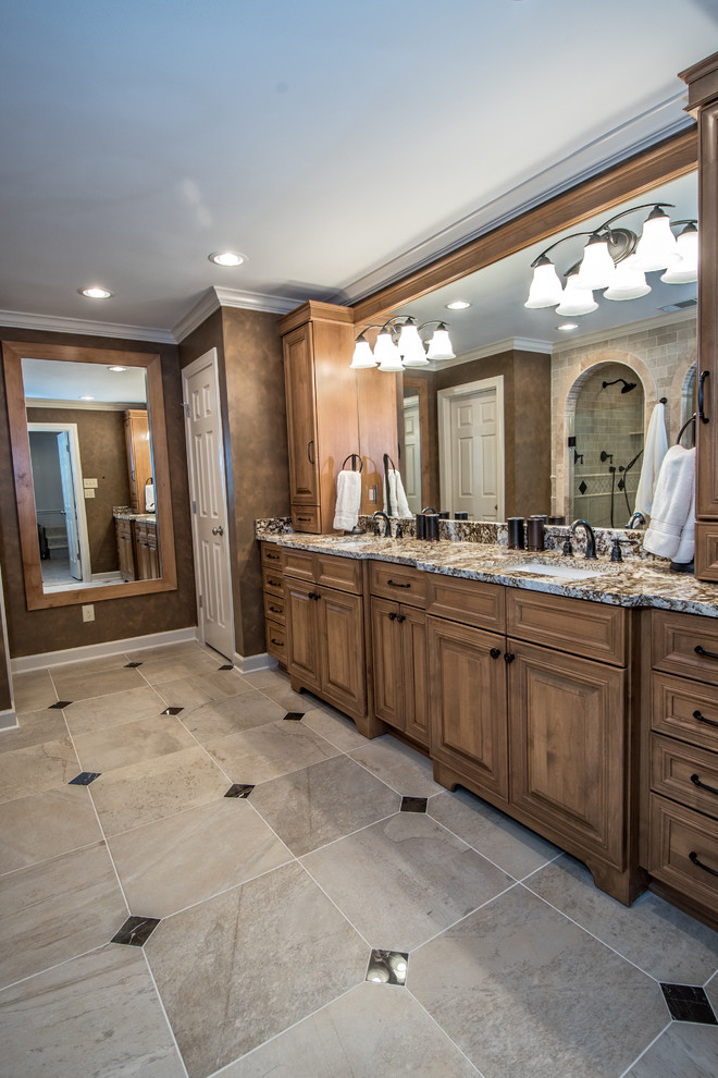 Double shower - mid-sized traditional master beige tile and porcelain tile porcelain tile double shower idea in Other with granite countertops, raised-panel cabinets, light wood cabinets, a two-piece toilet, brown walls and an undermount sink