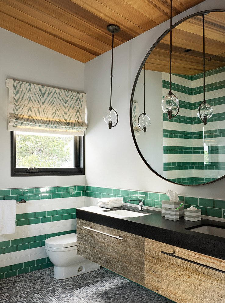 Inspiration for a contemporary shower room bathroom in San Francisco with flat-panel cabinets, distressed cabinets, a corner shower, a one-piece toilet, green tiles, white tiles, ceramic tiles, grey walls, mosaic tile flooring, a submerged sink, grey floors and black worktops.