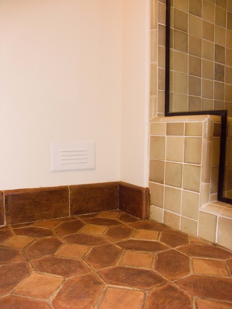 Immagine di una stanza da bagno classica con piastrelle in terracotta e pavimento in terracotta