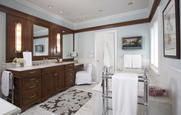 This is an example of a traditional bathroom in New York with dark wood cabinets and blue walls.