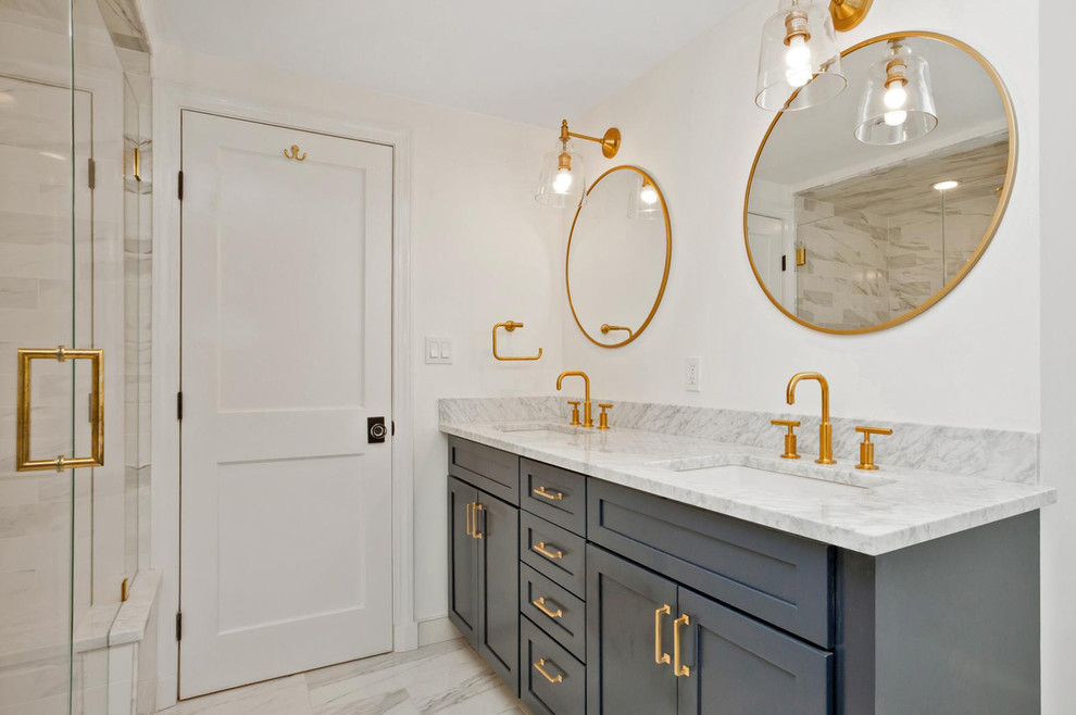 Photo of a large ensuite bathroom in New York with recessed-panel cabinets, grey cabinets, a corner shower, a two-piece toilet, white walls, marble flooring, a submerged sink, marble worktops, multi-coloured floors and a hinged door.