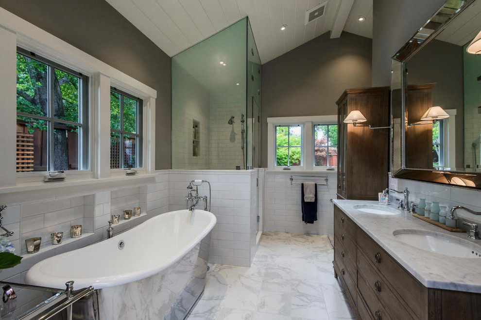 Example of a large transitional master white tile and subway tile marble floor and white floor bathroom design in Tampa with furniture-like cabinets, dark wood cabinets, gray walls, an undermount sink, marble countertops and a hinged shower door